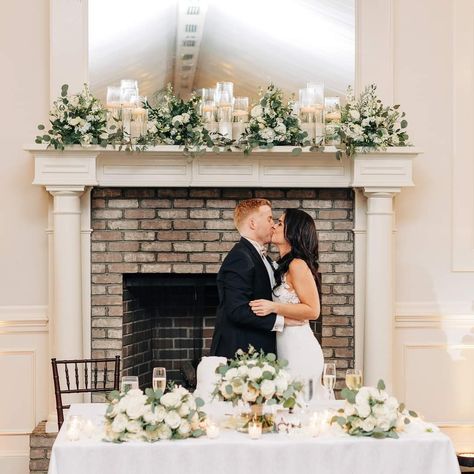 Fireplace Mantel Wedding Decor Bride And Groom Table In Front Of Fireplace, Wedding Decor Fireplace Mantles, Fireplace Wedding Reception, Mantel Decorating Ideas Wedding, Fireplace Ceremony Wedding, Mantle Wedding Decor, Wedding Mantel Decor, Wedding Mantle Decor, Bride Groom Table Decoration