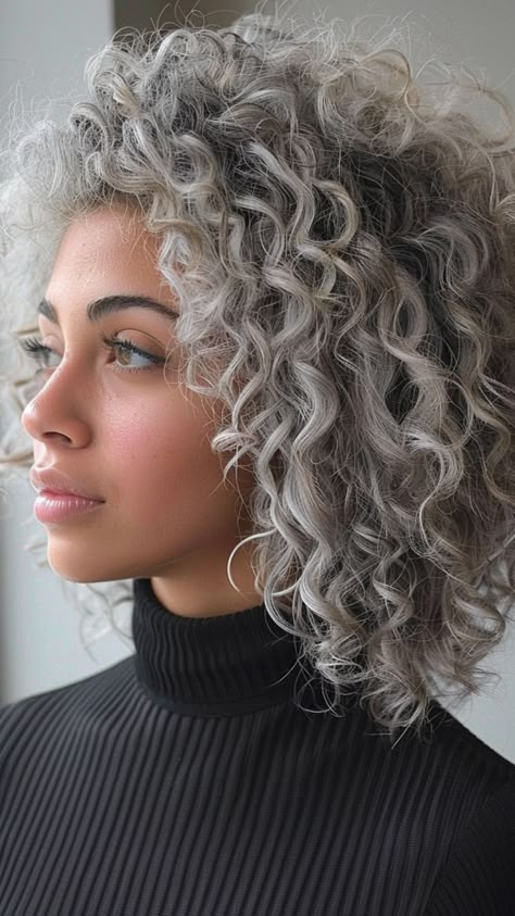 25 Trendy Silver Hair Color Ideas for a Show-Stopping Look Grey Balayage Curly Hair, Grey Permed Hair, Grey Hair Ideas Going Gray, Curly Hair Silver Highlights, Salt And Pepper Curly Hair, Gray Curly Hair Natural Curls, Curly Grey Hair Natural Curls, Wavy Silver Hair, Silver Curly Hair