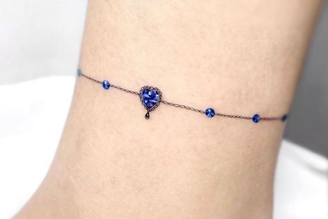 Tattoo Like Bracelet, Infinity Anklet Tattoo, Birthstone Anklet Tattoo, Beautiful Ankle Tattoos For Women, Friendship Bracelet Tattoo Design, 3d Ankle Bracelet Tattoo, Birthstone Tattoos For Women, Ankle Tattoos For Women Anklet Ideas Charm Bracelets, Ankle Bracelet Tattoos For Women Wrap Around