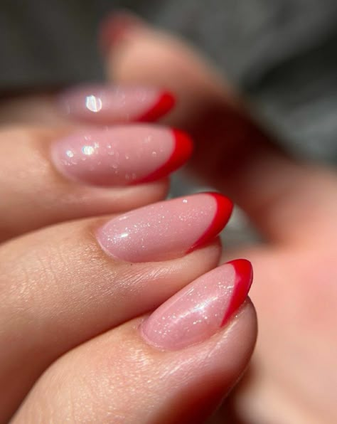 French nails, red , red tips , glitter base, almond nails, long nails Red French With Glitter, Glitter Base French Nails, Red French Tip With Chrome, Sparkle Red French Tip Nails, Red And Pink French Tip, Sparkly Red French Tip Nails Almond, Red French Chrome Nails, French Nails With Glitter Base, Red French Tip Nails With Glitter