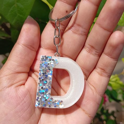 Hold the sparkle, grab the glam! ✨ Your initials just leveled up with some serious bling! Bling it on! ✨ These glittery ‘D’ & ‘K’ keychains are here to steal the spotlight! 🔦🤍 Get your customized resin alphabet keychains.💁💓🌟 Get yours now.😁 DM us for yours.♡♡ #buyitwithbuddy #inahemdabad #affordablegifts #resinglitterkeychain #resinkeychains #customisedgiftsindia #resinart #coolresinart #trending #inyourbudget #affordable #alphabetkeychain #alphabetresinkeyring #smallbusiness#custo... Resin Initial Keychain, Resin Alphabet, Initial Keychain, Customised Gifts, Epoxy Resin Art, Steal The Spotlight, Affordable Gifts, Buy Handmade, Get Yours Now