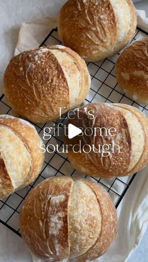 Emily, a passionate sourdough enthusiast, shares her delightful idea of gifting sourdough for the holidays. She crafted a batch of mini sourdough loaves, each weighing 70 grams, after a 15-hour cold ferment. These loaves were baked for 25 minutes, and for a special touch, wrapped in parchment paper and tied with twine. Perfect for sharing, these loaves are a testament to the joy of homemade baking. Follow her for more insights and homemade recipes. Bread As Gifts Holidays, Wrapped Sourdough Bread, Mini Sourdough Loaves Christmas, Bread As Gifts, Mini Artisan Bread Loaves, How To Gift Bread Loaves, How To Gift Wrap Sourdough Bread, Wrap Sourdough Bread As A Gift, Small Sourdough Loaves