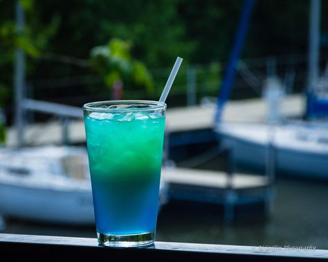 The Ozark Yacht Club Wine Galley’s Signature Drink takes its name from an Icelandic Landmark. Blue Lagoon -- as blue as the Caribbean waters from a 80s Brooke Shields motion 80s Brooke Shields, Lake Water Drink, Lake Water Cocktail, Light Blue Alcoholic Drink, Lake Water Drink Cocktail Recipes, Blue Motorcycle Drink, Blue Lagoon Drink, Blue Calypso Alcohol Drink, Blue Lagoon Mocktail