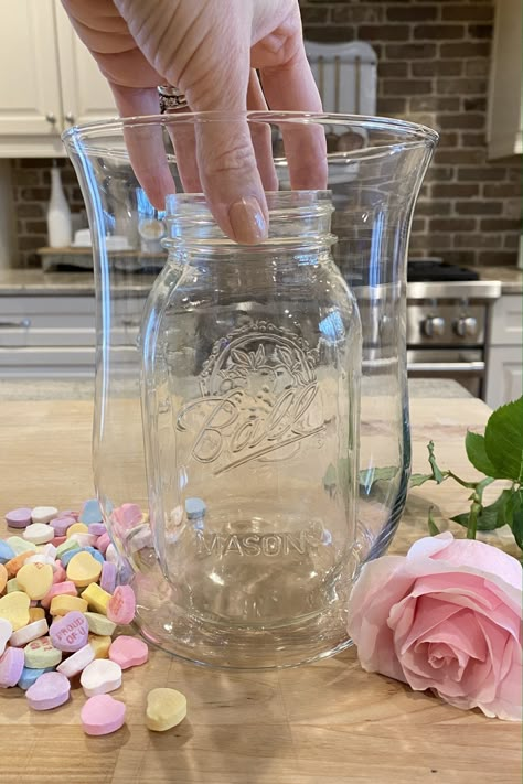 This sweet Valentine's Day floral arrangement is the perfect way to celebrate the holiday. It's easy, inexpensive, and beautiful! Use this arrangement as a centerpiece on the dining table, on the kitchen island, on a coffee table, or on an entry table. Wherever you display it, it's a sweet way to say, "Happy Valentine's Day!" at home. Find all the details on the blog. Valentine Bridal Shower Centerpieces, Floral Vases Ideas Decor, Valentine Jar Filler Ideas, Valentines Island Centerpiece, Valentines Banquet Centerpieces, Julep Cup Arrangement, Valentines Day Dining Room Table Decor, Center Piece For Dining Table Valentines, Valentines Dining Table Centerpiece