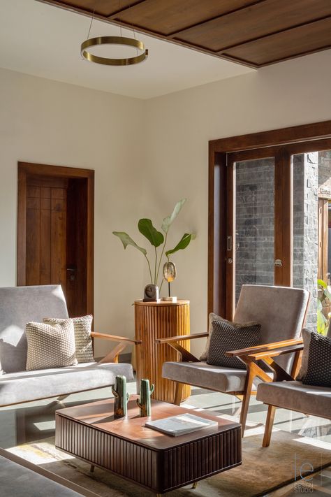 The Living room in the "Hope" residence by The Inside Eye Design Studio based in Kerala features custom-made teak furniture upholstered in Suede fabric. #livingroom #livingroomideas #contemporarylivingroom #Indianhomelivingroom #livingroomdesign #livingroomfurniture #livingroommodern #modernhomes #traditionalliving European Furniture Living Rooms, Kerala Interior Design Living Rooms, Kerala Living Room Designs, Living Room Kerala, Wooden Aesthetic, Interior Board, Traditional Design Living Room, Lounge Chairs Living Room, Aesthetic Boho