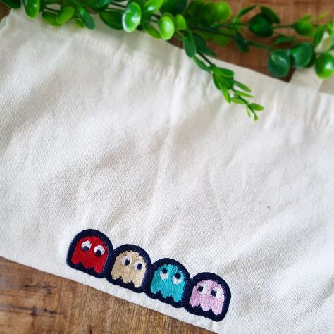 🎮 Level up your style with our custom tote bags! 🌟 Hand-stitched with iconic designs like this retro Pac-Man theme. Perfect for gamers and vintage lovers alike. Make a statement and carry your own custom icons. 🛍️👾 #customtotebag #pacman #handmade #retrogaming #embroidery #gameover #shoplocal #smallbusiness #peronlisedclothing #customdesign #comingsoon #nostalgia Custom Scrubs, Vintage Lovers, Custom Tote Bags, A Stitch In Time, Embroidery Motifs, Custom Icons, Xmas Presents, Pac Man, Vintage Lover