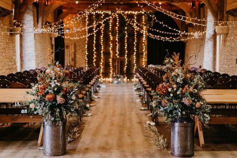 The Tythe Barn wedding ceremony room with fairy lights, milk churn florals and rustic wedding decor. Autumn Wedding Aisle, Wedding With Fairy Lights, Barn Rustic Wedding, Sage Green Bridesmaid Dresses, Sage Green Bridesmaid, Autumn Wedding Inspiration, Fall Barn Wedding, Wedding Isles, Sage Green Bridesmaid Dress