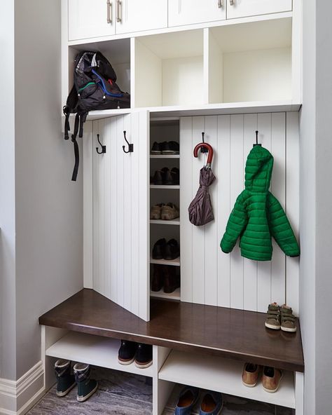 Our creative mudroom design features hidden shoe storage cabinets behind panelled doors dressed with coat hooks, perfect for a family. #allanchandondesign #mudroomdesign #familyfriendlydesign #customcabinetry #shoestorage #transitionaldesign #torontointeriordesign #torontodesigner #etobicoke #torontocustomhomes 📷@valeriewilcox Gömda Rum, Skjulte Rum, Ikea Shoe Storage, Vstupná Hala, Farmhouse Mudroom, Ikea Shoe, Coat Closet Organization, Koti Diy, Paint Cabinets White