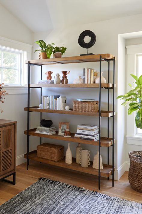 Crafted of wood with a warm vintage-acorn finish, the Kaili Bookshelf features rectangular open shelves in a sleek matte-black metal frame. Designed for versatile uses, this bookshelf is perfect for arranging with decor or plants in the living room, using as open storage in the bedroom or office and organizing serveware in the dining room or kitchen. #WorldMarket #AntonOfficeCollection #HomeOffice #HomeDecor Black Metal Bookshelf, Market Shelf, Wood Shelves Living Room, Office Furniture Decor, Unique Living Room Furniture, Wardrobe Laminate Design, Dining Room Shelves, Bedroom Nook, Shelf Decor Living Room