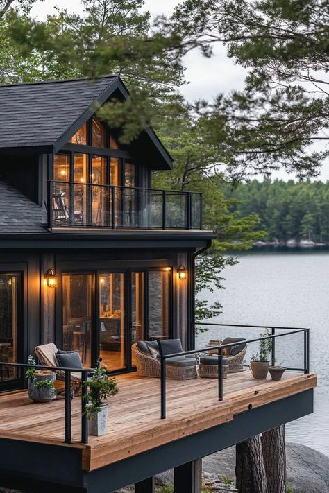 Rustic modern lake house facade with wraparound timber porch stunning Scandinavian lake view. Check out all of these charming and cozy rustic lake houses that perfectly blend with nature for the ultimate peaceful retreat. A Frame Lake Cabin, Cozy Lake House Exterior, Lake House Plans For Sloped Lot, Walkout Basement Lake House Plans, Lake House Decks And Patios, Lake Mountain House, Building A Lake House, Exterior Lake House Ideas, Big House Design Exterior