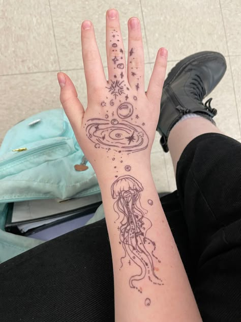 Aquatic Hand Tattoos, Jelly Fish Hand Tattoo, Jellyfish Neck Tattoo, Jellyfish Tattoo Aesthetic, Cool Jellyfish Tattoos, Jellyfish Tattoo Behind Ear, Jellyfish Wrist Tattoo, Galaxy Jellyfish Tattoo, Abstract Jellyfish Tattoo