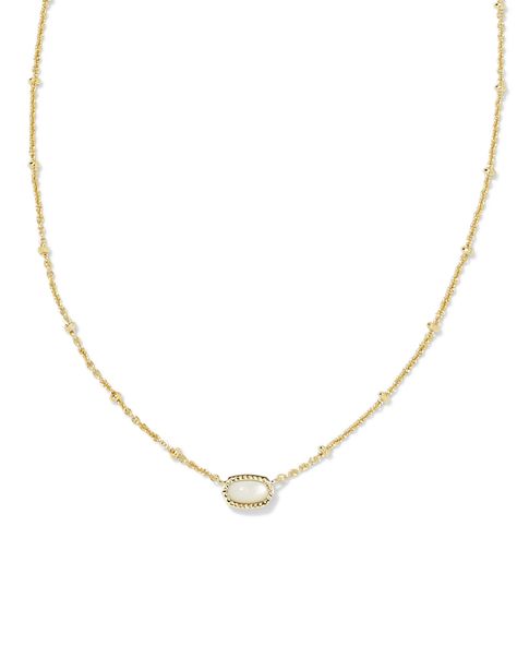 Our bestselling icon goes daintier (and cuter!) than ever in the Mini Elisa Gold Satellite Short Pendant Necklace in Ivory Mother-of-Pearl. Set on a textured satellite chain, this take on our signature shape is perfect for those with a more minimal aesthetic or anyone wanting to add some color to their layers. Metal 14k Yellow Gold Over Brass Material Ivory Mother Of Pearl Closure Lobster Clasp W/ Single Adjustable Slider Bead Size 15" Chain With 4" Extender, 0.39"L X 0.21"W PendantDue to the on Elisa Necklace Kendra Scott, Short Pendant Necklace, Kendra Scott Necklace, Minimal Aesthetic, Brass Material, Gold Pendant Necklace, Christmas Wishes, Christmas Wishlist, Kendra Scott