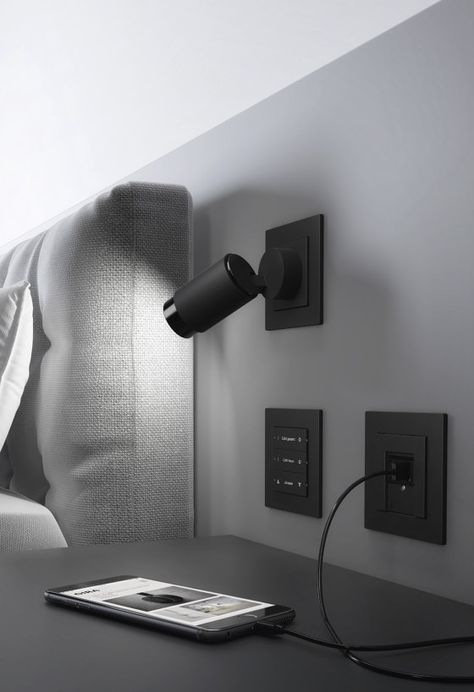 Lighten up: Plug & Light | News Bed Reading Light, Black Light Switch, Bedroom Reading Lights, Modern Light Switches, Headboard Lamp, Light Switches And Sockets, Switches And Sockets, Reading Lights, Hotel Room Design