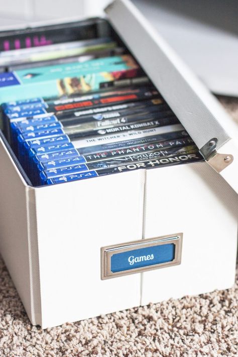 Love this organizing solution for a tv stand! Organize video games and all of the accessories inside pretty storage boxes. These Pop 'N Boxes are so cool because they look nice and fold flat when not used. I love how this blogger added bookplate labels to them! That painted TV stand plus the storage boxes made such an improvement! Board Games Ideas, Dvd Storage Ideas, Painted Tv Stand, Video Game Organization, Pretty Storage Boxes, Video Game Storage, Kids Storage Boxes, Swivel Tv Stand, Pretty Storage