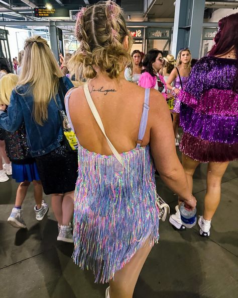 Photo from behind- Double pull through braids tied in a bun at the end of each with pink glitter down each braid. 
Lavender sequin fringe dress 
Taylor swift concert outfit Eras Tour Hair Ideas Updo, Concert Hairstyles Taylor Swift, Taylor Swift Eras Hairstyles, Era Tour Hairstyles, Taylor Swift Eras Tour Hair, Taylor Swift Hairstyles Concert, Taylor Swift Concert Hair, Taylor Swift Concert Hairstyles, Eras Tour Hairstyles