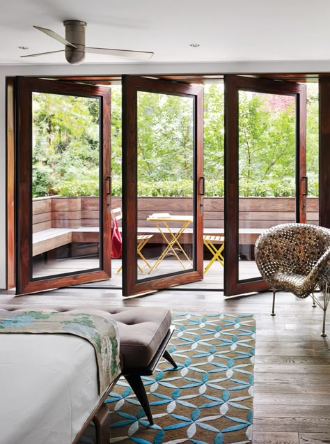 In Tia Cibani's master suite, the architect created a sizable terrace. The wood floors within the room run right out of doors, establishing a subtle sense of continuity. Thus, says Dubbeldam, “the balcony becomes part of the bedroom.” The coin chair is by Johnny Swing. The bed is from Design Within Reach. Terrasse Design, Balcony Doors, Exterior Modern, Attic Renovation, Bedroom Balcony, Sliding Glass Doors, Terrace Design, Chelsea House, Balcony Design