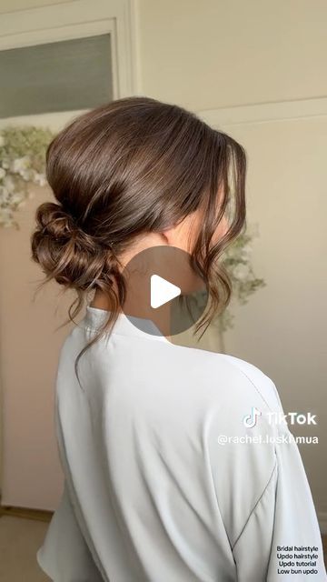 Kristina Youssef - K Y K ® on Instagram: "California stylist @rachel.luskhmua shares how to create a stunning textured clean bun using cult favourite @kykhaircare Magic dust volume powder.   Use the powder to add volume at the crown before back combing, and use it to add texture and fullness before pinching on the hair.  Add it from roots to ends to create the perfect texture in your fringe for facial framing." Low Loose Updo Wedding Bridesmaid Hair, Easy Low Bun For Wedding Guest, Bun With Loose Strands, Bridal Low Messy Bun, Higher Updos, Bridal Low Updo With Veil, Low Bun With Face Framing Pieces, Bride Hairstyles High Updo, Low Bun For Shoulder Length Hair