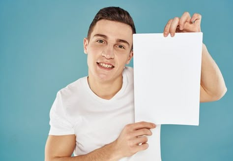 Young man holding a sheet of paper with ... | Premium Photo #Freepik #photo #holding-sign #holding-banner #holding-paper #business-executive Person Holding Paper Reference, Person Holding Sign, Man Holding Paper, Holding A Piece Of Paper, Mtn Logo, Holding Sign, Holding Paper, 30 Year Old Man, Holding A Sign