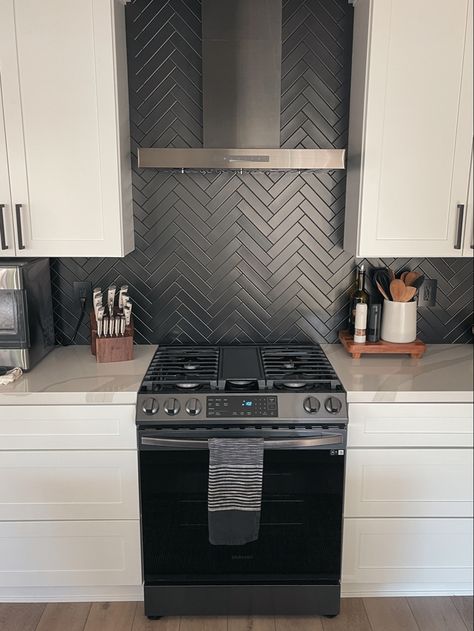 Matte black herringbone kitchen backsplash, white shaker cabinets. Matte Black Herringbone Backsplash, White Cupboards Black Backsplash, Black Stacked Backsplash, Black Kitchen White Backsplash, Black Backsplash Wood Countertop, Black Matte Backsplash Kitchen, Black Backsplash Black Grout, White Subway Tile Kitchen Backsplash With Black Accent, Black Herringbone Kitchen Backsplash