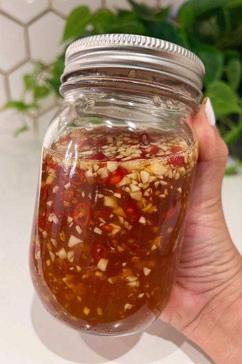 Impress your taste buds with Vietnamese Fish Sauce showcased in a glass mason jar which includes fresh garlic and Thai chili peppers. Egg Roll Sauce, Fish Dipping Sauce, Vietnamese Fish Sauce, Vietnamese Sauce, Picky Bits, Vietnamese Egg Rolls, Vietnamese Fish, Recipes With Fish Sauce, Citrus Fish