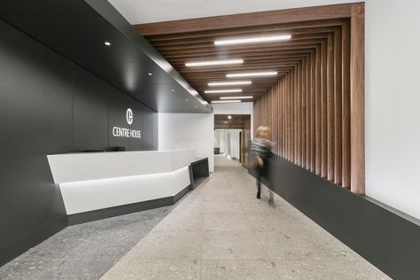 Narrow entrance lobbies to large upper office floor plates is a common site. With precise angular shifts of floor finishes, reception desk, wall & ceiling cladding, the perspective of a narrow corridor has been altered. #plydesign #interiors #office #centrehouse #receptionlobby Reception Desk Wall, Narrow Entrance, Narrow Corridor, Entrance Office, Ceiling Cladding, Entrance Lobby, Kids Gym, Desk Wall, Office Lobby