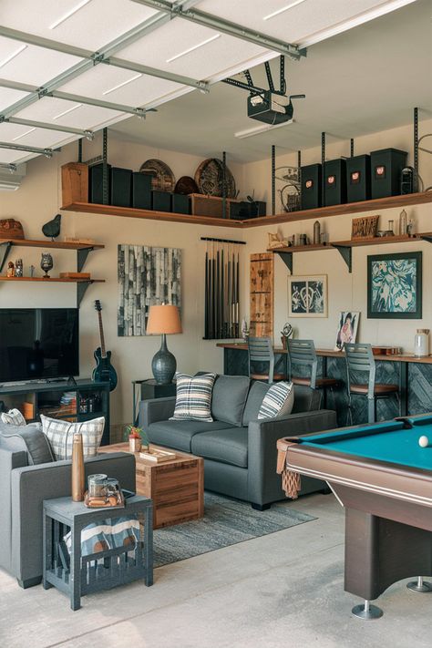 A photo of a garage turned man cave with various items. There's a sofa, a coffee table, a TV, a bar with a few chairs, and a pool table. There are also shelves with decorative items, a guitar, and a lamp. The walls have a few pieces of artwork and a few storage units. The floor is covered with a rug. Less Man Cave Sitting Area, Man Cave Garage Wall Shelves, Pool Table Garage, Small Garage Hangout Ideas, Garage With Pool Table, Garage Tv Ideas, Garage Pool Table Room, Garage Pool Table, Garage Hang Out Space