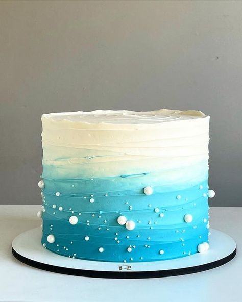 11. Blue Ombre Ruffle Cake When you start planning any party, you want to be creative—whether it is your decoration, dress, dessert or a cake idea. You will want the party pleasurable for everyone. Sea Theme Cake Ocean, Simple Ocean Cake, Simple Ocean Theme Cake, Ocean Cake Ideas Simple, Ocean Cake Birthday, Ocean Sheet Cake, Sea Cake Design, Sea Cakes Birthday, Blue Cake Decoration