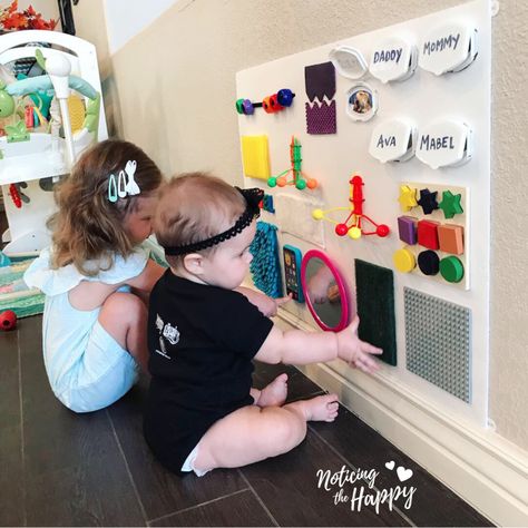 Dollar Store Busy Board – Noticing the Happy Infant Busy Board Diy, Infant Activity Board, Busy Board For 1 Year, Wall Mounted Busy Board, Homemade Busy Board, Baby Sensory Board, Diy Busy Board, Toddler Activity Board, Busy Board Baby