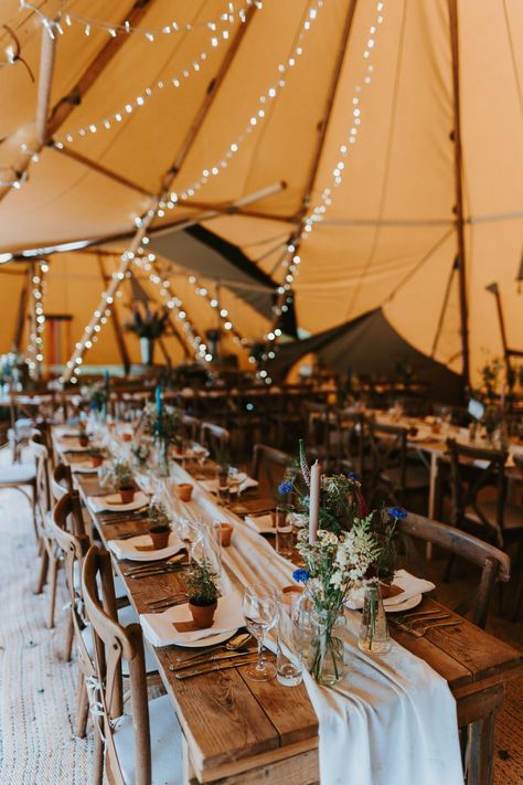 Tipi Wedding Decor Rustic Tables Jonny Gouldstone Photography #tipiwedding #weddingideas Tipi Wedding Photography, Tipi Decoration Wedding, Boho Festival Wedding Decor, Festival Wedding Table Decor, Rustic Decoration Wedding, Wedding Tipi Tent, Festival Wedding Table Decorations, Boho Tipi Wedding, Rustic Wedding Long Table Decor