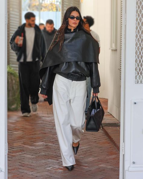 During a laid-back shopping spree in West Hollywood, Kendall was spotted in a black leather caped bomber jacket from Phoebe Philo. The entire ensemble hailed from the renowned fashion veteran's new eponymous label, which finally made its highly anticipated debut in late October. Kendall Jenner's endorsement remains unparalleled when it comes to promoting the brand. Outfit Nero, Stile Kendall Jenner, Scarf Coat, Cape Outfit, Leather Scarf, Kendall Jenner Street Style, Style Casual Chic, Kendall Style, Stylish Winter Outfits