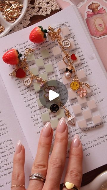 SAORI CALUYA DESIGN |  Artsy & Crafty on Instagram: "Materials 👇🏼❤️

- UV DTF bookmark decals & bookmark acrylic blank is available on our shop (link in bio 🫶) 
- chain: 3x7.5 mm gold chain (Amazon)
- strawberry charm (Amazon) 
- bunch of charms (i got 350pc charm bundle, Amazon) 
- initial charm (also from Amazon) 

All amazon items are in my storefront > “ Crafting Tools & Supplies “❤️❤️ 

#diygift #diybookmark #bffgoals #dateideas #crafting #craftymoms #charmbracelets #booklover" Charm Diy Craft Ideas, Bookmark Charms, Bookmark Charm, Charm Crafts, Bookmark Acrylic, Caluya Design, Craft Nights, Amazon Items, Charm Bookmark