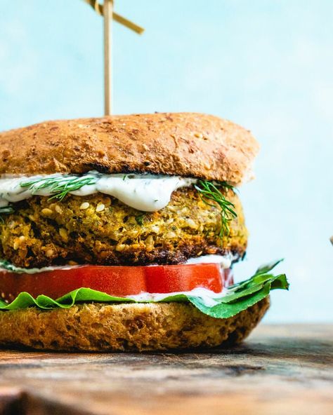 This insanely good falafel burger is easy to make and bursting with Mediterranean flavor! Smother in sauce for an epic vegetarian or vegan dinner. This healthy dinner recipe takes 45 minutes or less to cook and is perfect for those warm summer evenings. #vegan #vegetarian #falafel #veggieburger #burger #recipe Burger Recipes Healthy, Turkey Burger Recipes Healthy, Falafel Burger, Falafel Burgers, Lemon Tahini Sauce, Best Veggie Burger, A Couple Cooks, Veggie Burgers Recipe, Homemade Tzatziki