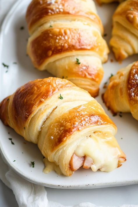 These quick & easy ham and cheese crescent rolls are perfect for a quick weeknight dinner, after-school snack, or party appetizer. Pillsbury Crescent Recipes Ham And Cheese, Breakfast Made With Crescent Rolls, Main Dish Finger Foods, Ham And Cheese Croissants Recipe, Hot Ham And Cheese Party Rolls, Easy Snack Ideas For School, Ham And Cheese Croissant Rolls, Ham And Cheese Crescents, Lunch Meat Ham Recipes