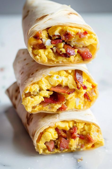 Loaded with fluffy, cheesy scrambled eggs and topped with perfectly crispy bacon, these bacon and egg breakfast wraps are comfort food at its best. Egg Bacon Breakfast Ideas, Breakfast Fajitas Eggs, Turkey Bacon Breakfast Burrito, Breakfast Sale Ideas, Bacon Egg And Cheese Breakfast Burrito, Scrambled Eggs Wrap, Bacon Egg And Cheese Wrap, The Perfect Breakfast, Yum Breakfast Ideas