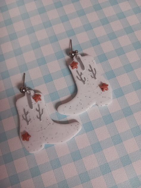 These earrings are handmade from polymer clay Eras Tour Accessories, Cowboy Boot Earrings, Boot Earrings, Personalized Cosmetic Bags, White Cowboy Boots, Clay Making, Bag Quotes, Clay Dangle Earrings, How To Make Clay