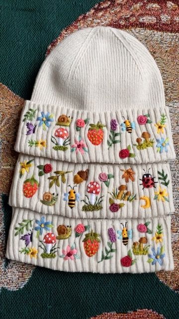 Kerri 💐🐇🐝 on Instagram: "Such a sweet set of custom dreamscape beanies. They look like a cute lil family. I’ll be working on these for the foreseeable future and I couldn’t be happier! Which part is your favorite? 🥰🌿🐌🍄🦋🍓🌙🌸🐝🌹💖" Embroidery Beanie Ideas, Beanie Embroidery Ideas, Baby Hat Embroidery, Embroider Beanie, Beanie Embroidery, Ceramic Wall Flowers, Embroidered Beanies, Diy Embroidery Projects, Outfitinspo Style