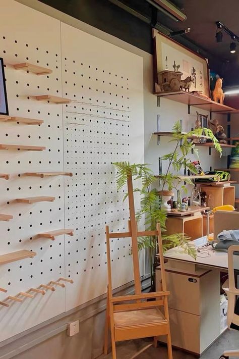 A full wall of pegboard creates a unique and practical office wall design, offering customizable storage and organization options for a modern and functional workspace. Teacher Classroom Setup, Studio Space Ideas, Peg Board Walls, Wooden Pegboard, Pegboard Wall, Office Wall Design, Pegboard Organization, Home Greenhouse, Craft Things