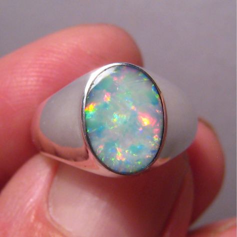 An affordable silver ring for men with an intriguing opal that displays mostly red and blue in mid range brightness.  The ring is 12 mm across north to south and weighs 5 grams. Opal Ring Men, Opal Mens Ring, Men Ornaments, Silver Ring For Men, Australian Opal Ring, 20 Birthday, Signet Ring Men, Coober Pedy, Beautiful Wedding Rings