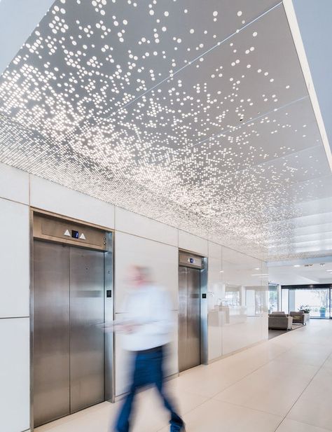 Custom perforated metal ceiling system for NCX 6060 Aesthetic False Ceiling, Perforated Metal Panel, False Ceiling Ideas, Elevator Lobby, Lift Lobby, Interior Ceiling Design, Ceiling System, Modern Office Design, Lobby Design