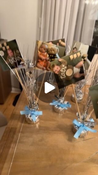 Meghan on Instagram: "Attempting to be a Pinterest mom with these centerpieces for my son’s first birthday!   Everything I used was mostly from the dollar tree.   - balloon weights  - 4x4 pictures  - skewers  - tape  - white cardstock - ribbon  These weren’t difficult to make at all and were so much cheaper than getting flowers. I was pleasantly surprised with how they turned out! 🩵#dollartree #firstbirthday #firstbirthdaydecor #diy #crafts #centerpieces #boymom #monthlymilestones #pinterestmom" Dollar Tree First Birthday, Balloon Weights Diy Centerpieces, Picture Centerpiece Ideas Birthday, Photo Centerpieces Diy Birthday, Diy Centerpieces For Party Birthdays, First Birthday Centerpieces Boy, 1st Birthday Centerpiece Ideas, Birthday Centerpieces Kids, Dollar Tree Centerpieces Birthday