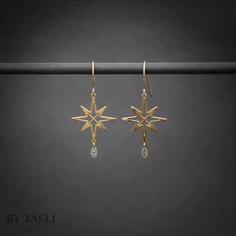 "You'll shine when you will wear this celestial dangle earrings. This dangle north stars with hanging zircon stone is perfect to wear at work, holidays, and even for a party. ★Comes in our signature gift box, ready for gift giving. ★ Available in Gold [ gold-filled ear wires & gold plated brass & zircon stone ] ★ Earring size (star+zircon) 1\"x0.80\". Thanks for shopping at ByYaeli♥ All images, texts & products are property of ByYaeli ©2020" Gold Star Earrings Dangle, Gold Star-shaped Celestial Earrings, Elegant Gold Star-shaped Crystal Earrings, Elegant Gold Star Shaped Crystal Earrings, Gold Celestial Star Earrings, Elegant Brass Jewelry With Star Charm, Elegant Star-shaped Brass Jewelry, Gold Star-shaped Diamond Earrings, Gold Star-shaped Crystal Earrings For Pierced Ears