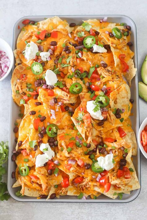 Instant Pot Chicken Nachos are done in minutes and a total crowd pleaser. A simple, lime-infused marinade for chicken breasts produces flavorful and moist shredded chicken with a hint of heat. Use it atop baked nachos, for a great weeknight dinner or appetizer. #instantpot #nachos #easyrecipe #instantpotrecipe #instantpotchicken #instantpotchickenrecipe Homemade Nachos Chicken, Sheet Pan Nachos Chicken, Chicken Nachos Recipe Easy, Nachos Recipe Chicken, Healthy Chicken Nachos, Moist Shredded Chicken, Loaded Chicken Nachos, Shredded Chicken Nachos, Nachos Chicken