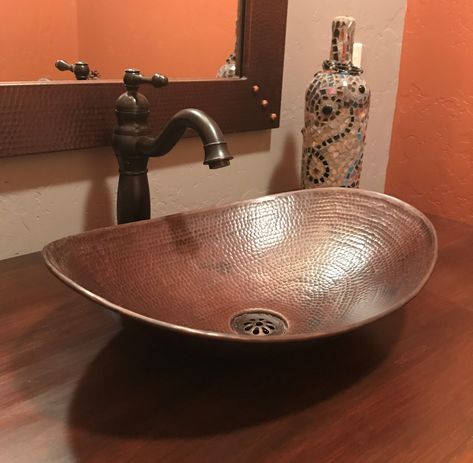 SimplyCopper 18" x 11-1/2" oval Canoa design is a unique design piece, created of 17-gauge copper which is hand-hammered to provide a elegant look. The finish is done by firing a dark patina, then brushing to highlight the undertones of copper in the sink. This sink is installed as a vessel. Copper Bathroom Ideas, Sedona House, Vessel Sinks Bathroom, Copper Sink Care, Copper Vessel Sinks, Bucket Sink, Copper Sinks, Interior Hotel, Copper Sink Bathroom