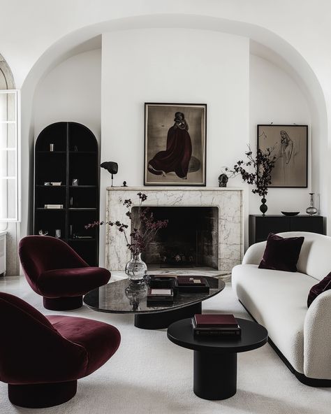 These stunning interiors show how a deep burgundy accent can transform a space.🤌🏻🍷 The rich velvet chairs and pillows pop against the soft neutrals, creating a perfect balance of warmth and sophistication. The dark red details, from the lush upholstery to the elegant rugs, bring a sense of depth and elegance without overpowering the minimalist design. Paired with sleek black furniture and subtle art pieces, the space feels both modern and timeless.✨ #minimalistinterior #minimalisthome #mi... Black Minimalist Interior, Symmetry Interior Design, Red Accent Interior Design, Interior Design Vintage Modern, Dark Bedroom Modern, Dark Red Interior Design, Maroon Interior, Great Room Decor, Burgundy Furniture