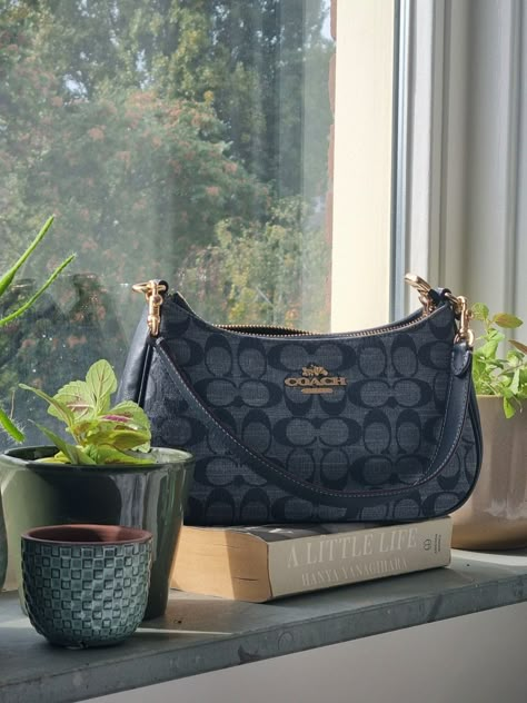 Coach Teri Shoulder Bag in Signature Denim Blue with gold hardware, A Little Life by Hanya Yanagihara, plants Coach Denim Shoulder Bag, Coach Blue Shoulder Bag, Coach Teri Shoulder Bag Aesthetic, Coach Blue Bag, Blue Coach Shoulder Bag, Denim Coach Bag, Coach Denim Bag, Blue Coach Bag, Coach Teri Shoulder Bag