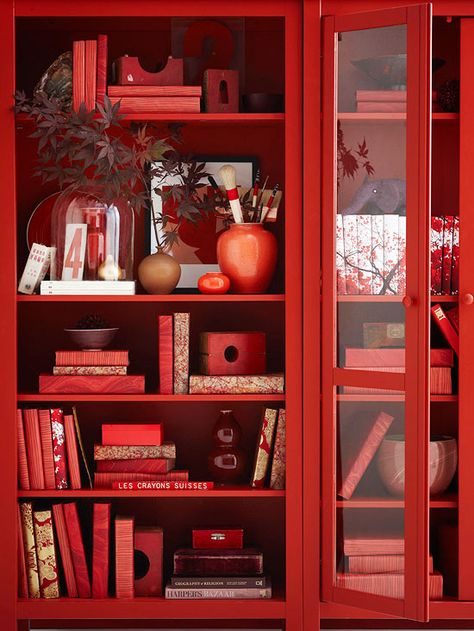 Bookcase Beauty.   Transform your everyday bookshelf into an autumnal display with a few simple tweaks. First, to create a consistent and graphic look, cover books with festive paper -- we love these tree- and floral-inspired prints. Then incorporate natural elements and accessories in fall hues. Red Bookcase, Monochromatic Interior, Feng Shui Elements, Simply Red, Red Decor, Red Rooms, Root Chakra, Red Aesthetic, Shades Of Red