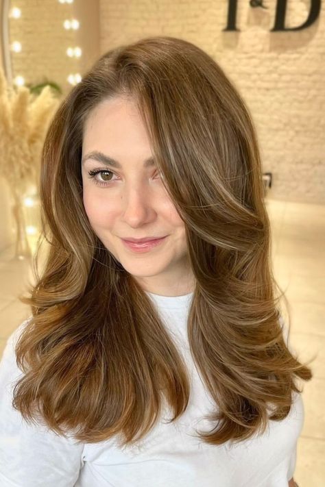 Woman with luxurious golden chestnut waves Brown Golden Hair Color, All Over Golden Brown Hair Color, Hair Color Golden Brown, Rich Golden Brown Hair, Messy High Ponytails, Golden Hair Color, Medium Golden Brown, Golden Brown Hair Color, Long Layered Cuts