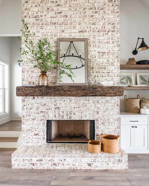 Check out this stunning fireplace design! Our client chose a floor-to-ceiling brick surround, complemented by a beautiful wooden mantel. The built-in cabinetry and floating shelves add both style and functionality, making this the perfect living space!   Builder: @restorebuildanddesign  Design: @hawkinsandgraydesign  Photos: @lyndseymariephotography