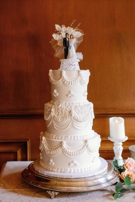 A three-tiered wedding cake with delicate lace design including a vintage cake topper of a bride and groom. | Photo by Sarah Block Photography Delicate Wedding Cake, Three Layer Cake Wedding, Vintage Wedding Cake With Topper, Traditional Wedding Cake Topper, Wedding Cake Designs Vintage, Victorian Style Wedding Cake, Retro Wedding Cakes Vintage, Vintage Piped Wedding Cake, Vintage Wedding Cake With Flowers