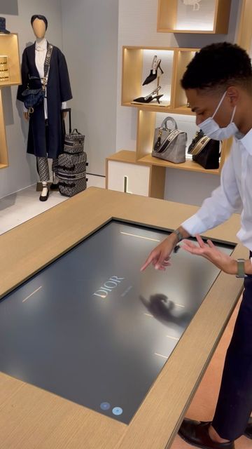 Rettech | Retail Tech Experiences on Instagram: "Inside ABC @dior , SoHo (NYC) where clients can: - Browse a collection of bags through a table touch screen - Personalize their bag’s pattern - Add initials and emojis - See how the bag looks like in 3D - Scan a QR code to save their custom bag for later - Receive the link in their email and share it with friends. Get inspired!💎 #tech #retail #retailtech #digitalexperience #abcdior #abcdiorpopup #diornyc #luxurytech #digitalluxury #newretail # Big Ipad, Touch Screen Table, Fragrance Display, Dior Brand, Digital Retail, Media Table, Sales Center, Soho Nyc, Retail Experience